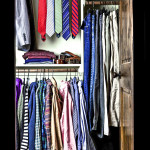 A man's closet prior to packing for Paris.