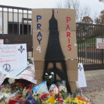A sign asks passersby to Pray for Paris at the memorial at the French Embassy in D.C.