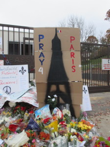 A sign asks passersby to Pray for Paris at the memorial at the French Embassy in D.C.