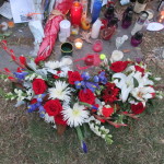 Blue, white and red flowers adorn the memorial at the French Embassy in D.C.