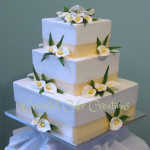 White Calla Lilies are incorporated into a wedding cake design.