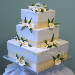 White Calla Lilies are incorporated into a wedding cake design.