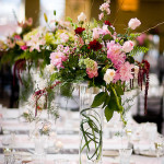 Tall flowers on a table that don't obstruct guests' views.