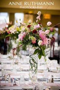 Tall flowers on a table that don't obstruct guests' views.