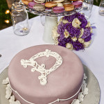 Wedding cake and macaroons nearby.