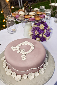 Wedding cake and macaroons nearby.