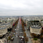 An aerial view of the Champs-Elysees from the top of the Arc de Triomphe. If you look closely, you can see the Ferris Wheel at the Place de la Concorde in the background.