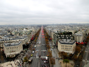 An aerial view of the Champs-Elysees from the top of the Arc de Triomphe. If you look closely, you can see the Ferris Wheel at the Place de la Concorde in the background.